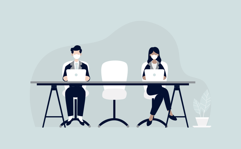 Illustration of two people sitting at a desk, both wearing white face masks and working on laptops amid a covid-19 update. They are seated on either side of an empty chair, with a small plant off to the right on the ground. The background is a light grey color.