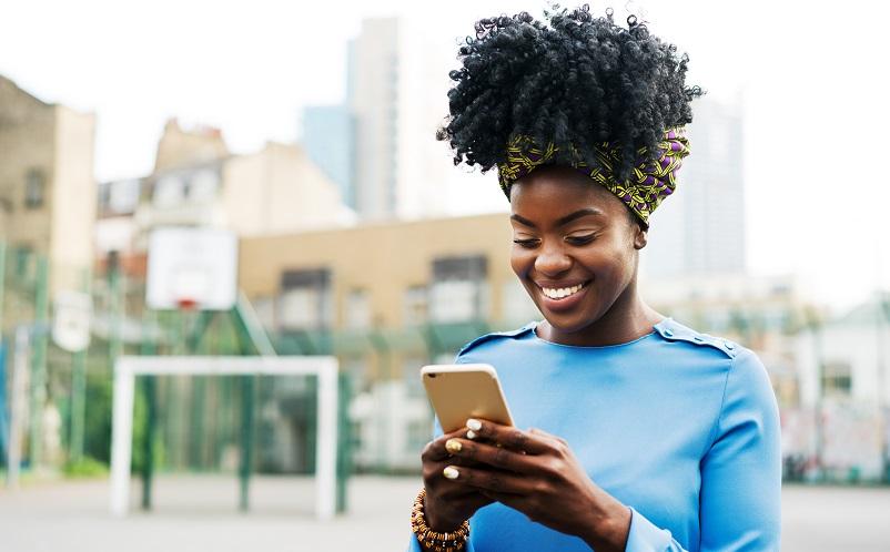 Woman smiling holding mobile phone