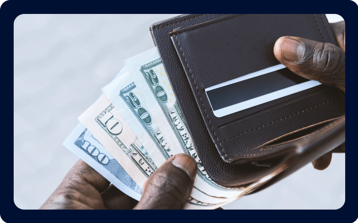 African immigrant holding a wallet with money.