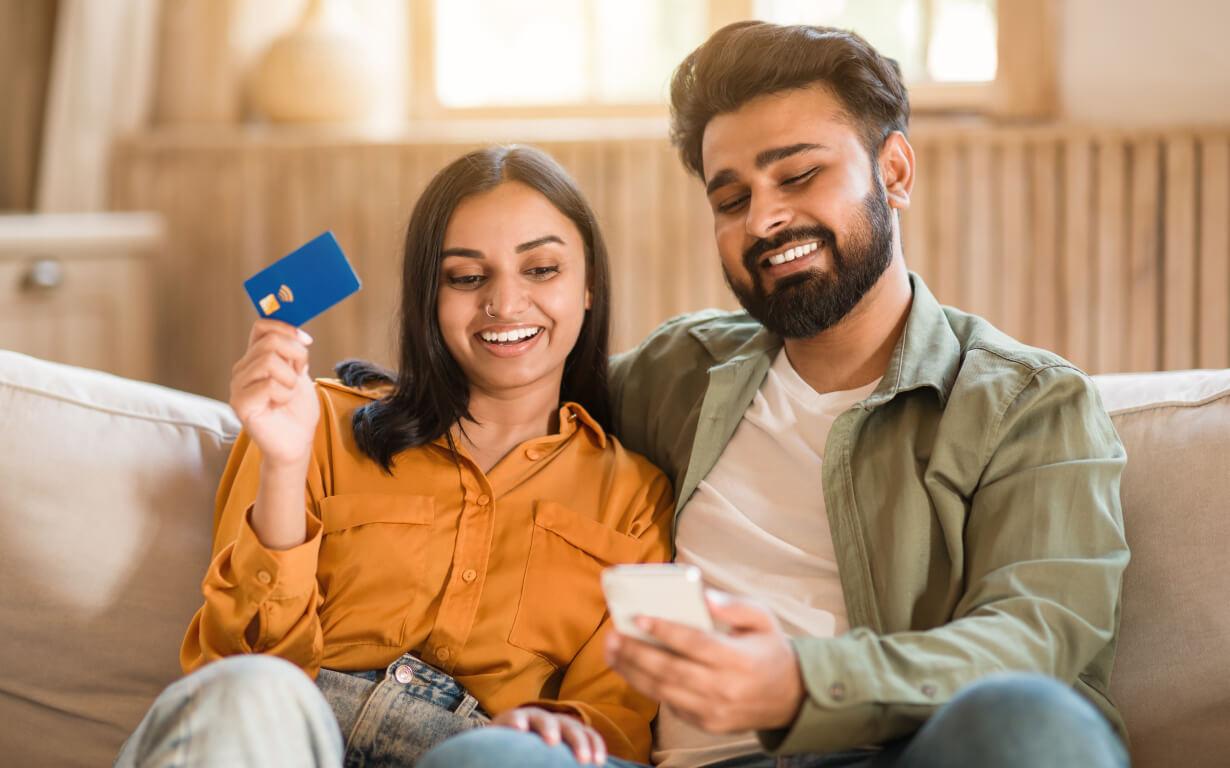 Indian couple with credit cards.